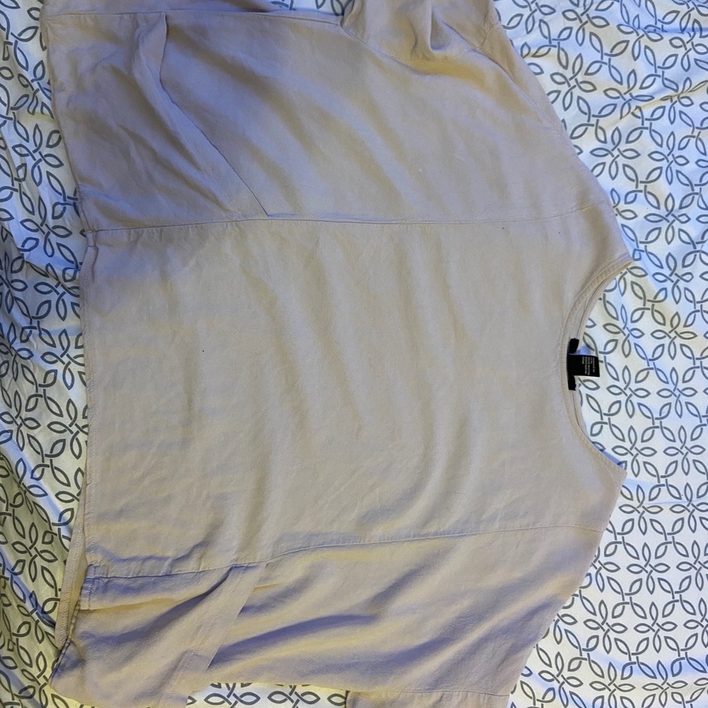 A cream colored flowy crop top